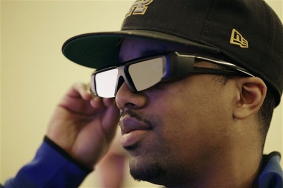 Richard Lawler watches Mitsubishi's 92-inch Home Cinema 3-D HDTV using 3-D glasses at a CES press event on Tuesday, Jan. 4, 2011. 